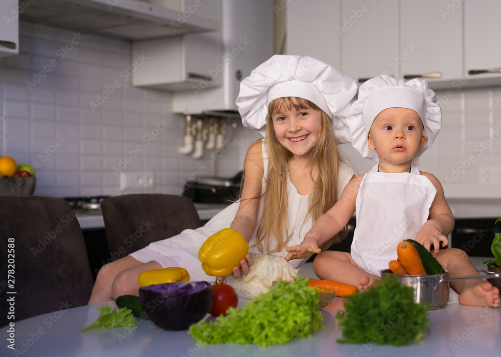 little girl and boy, white chef hat, vegetables little girl and boy, white chef hat, vegetables