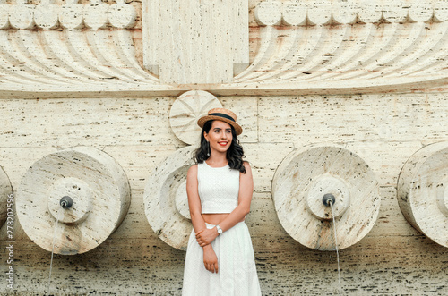 young beautiful candid woman in white dress , street style photo