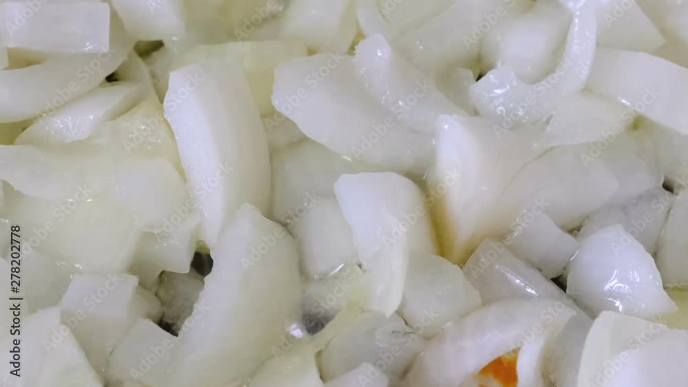 White onion chopped into small pieces stewed with red fresh tomatoes with olive oil on a non-stick teflon griddle, video clip close-up shooting using zoom and camera movement White onion chopped into small pieces stewed with red fresh tomatoes with olive oil on a non-stick teflon griddle, video clip close-up shooting using zoom and camera movement