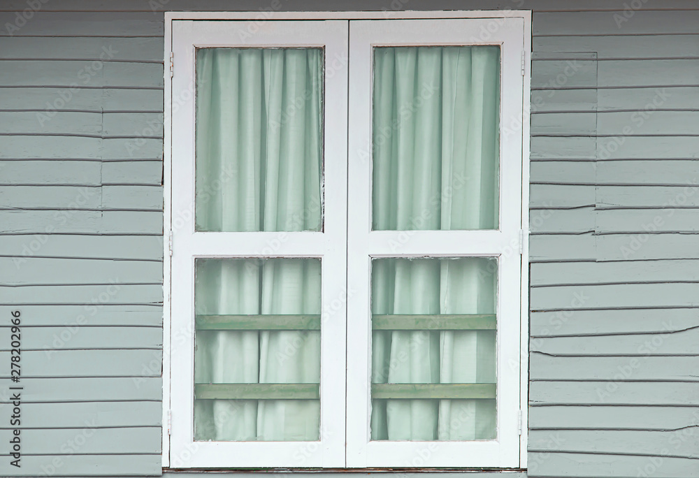 White window doors on old gray wooden houses. White window doors on old gray wooden houses.