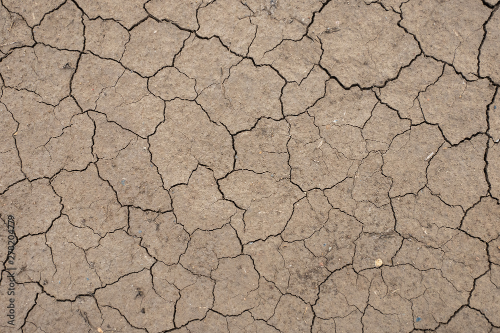 Land with dry and cracked ground, background image, top view Land with dry and cracked ground, background image, top view