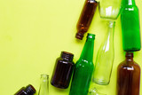 Glass bottles on green background.