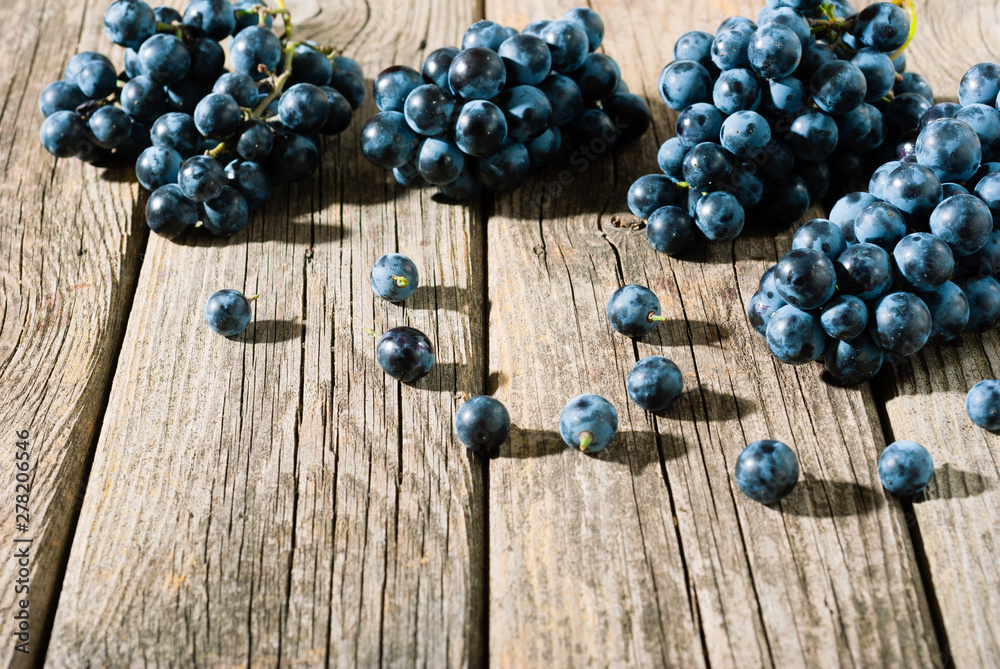 red grapes on old weathered wooden table red grapes on old weathered wooden table