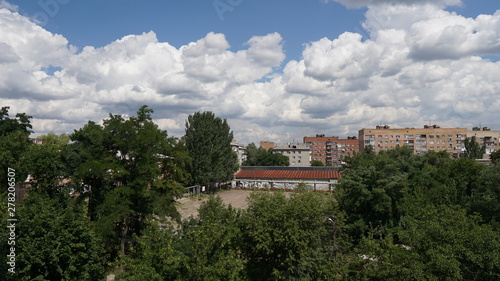View of the city with a clouds in a summer day over background