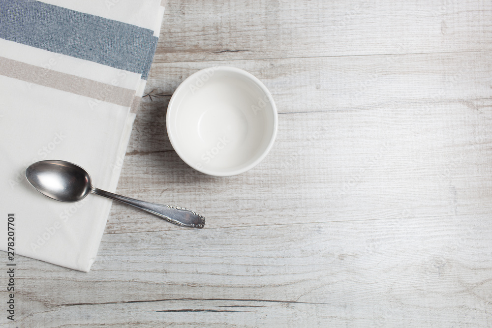 Empty clean bowl and spoon on the table,top view.Copy space Empty clean bowl and spoon on the table,top view.Copy space