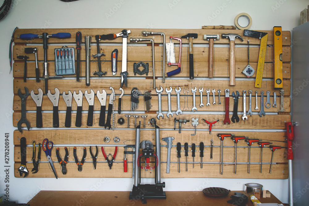 cubrir Distante La base de datos assortment of tools on a garage wall hanger Stock Photo | Adobe Stock