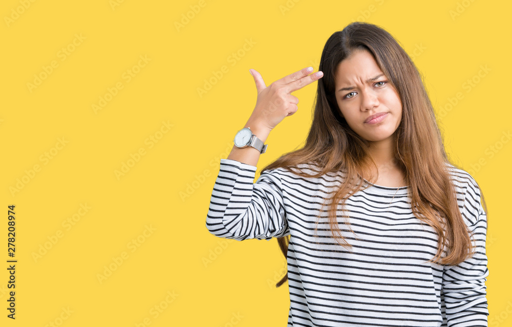 Young beautiful brunette woman wearing stripes sweater over isolated background Shooting and killing oneself pointing hand and fingers to head, suicide gesture. Young beautiful brunette woman wearing stripes sweater over isolated background Shooting and killing oneself pointing hand and fingers to head, suicide gesture.