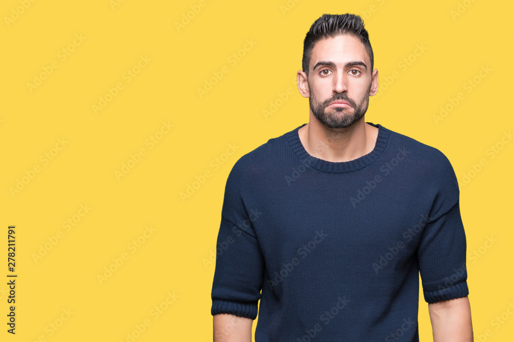 Fototapeta premium Young handsome man wearing sweater over isolated background depressed and worry for distress, crying angry and afraid. Sad expression.