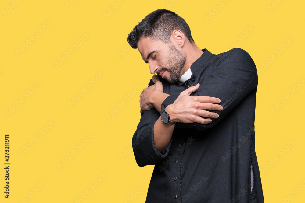 Young Christian priest over isolated background Hugging oneself happy and positive, smiling confident. Self love and self care Young Christian priest over isolated background Hugging oneself happy and positive, smiling confident. Self love and self care