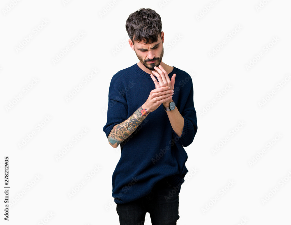 Obraz premium Young handsome man over isolated background Suffering pain on hands and fingers, arthritis inflammation