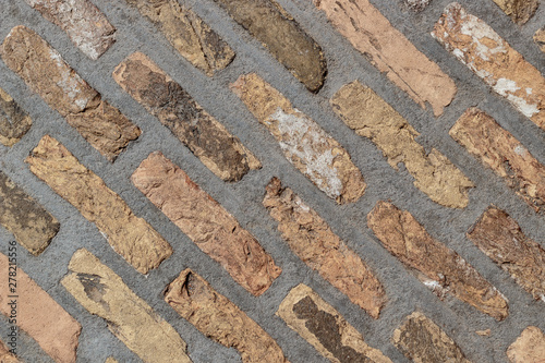Texture of a floor made from bricks. Old bricks in concrete.