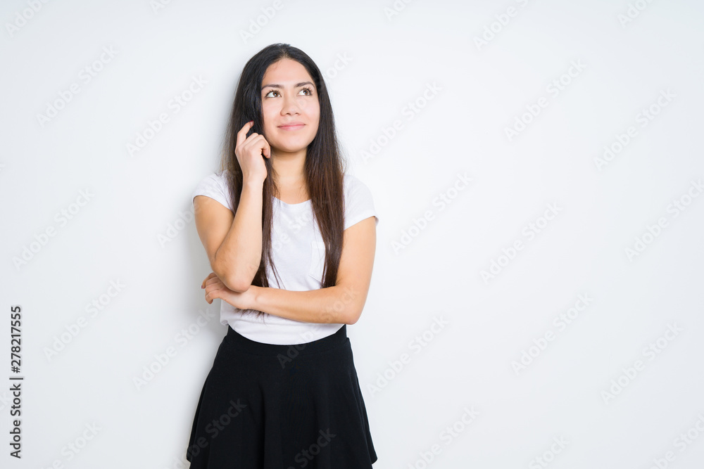 Beautiful brunette woman over isolated background with hand on chin thinking about question, pensive expression. Smiling with thoughtful face. Doubt concept. Beautiful brunette woman over isolated background with hand on chin thinking about question, pensive expression. Smiling with thoughtful face. Doubt concept.