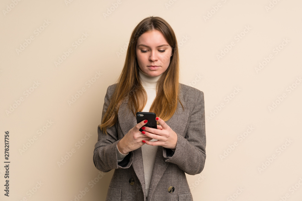 Young business woman sending a message with the mobile Young business woman sending a message with the mobile