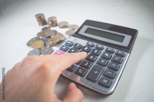 Man's hand is counting lots of coins. Asia, Thailand.