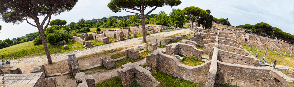 Panoramic view - 180 degree in the excavation ruins at Ostia Antica - from the Decumanus Maximus to the gym of Neptune thermal baths with the view of the republican warehouses