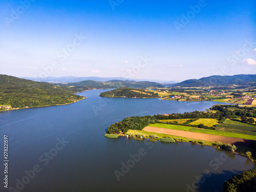 Aerial view of lake, forest and agriculture field by the water, at summer. Gruza lake near the Kragujevac in Serbia.