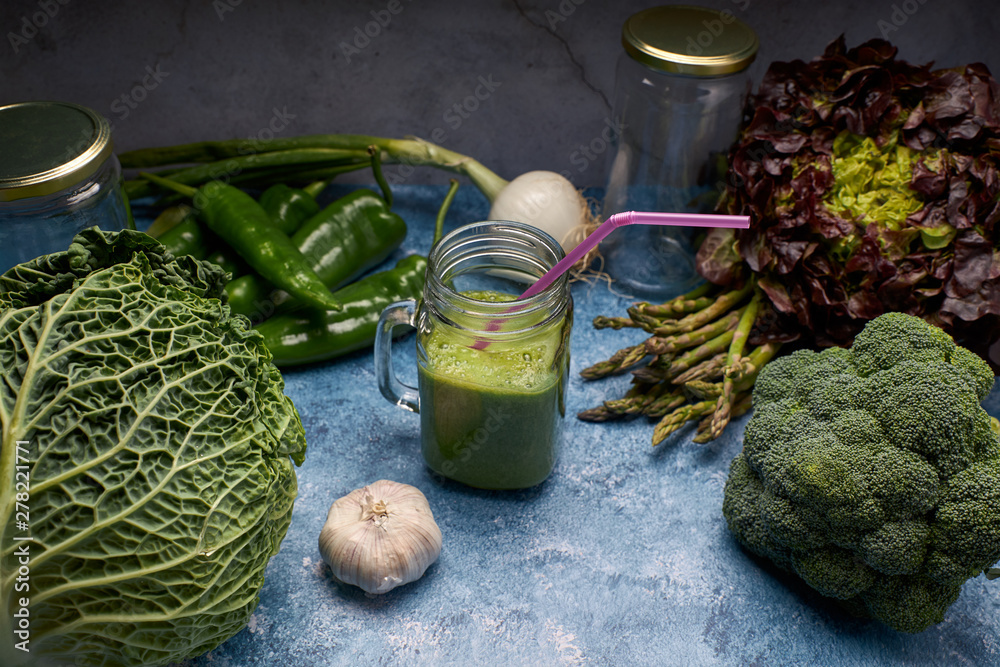Obraz premium view of a pitcher of tasty green smoothie of fresh vegetables for vegans