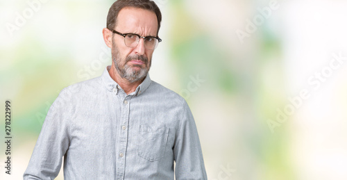 Handsome middle age elegant senior man wearing glasses over isolated background skeptic and nervous, frowning upset because of problem. Negative person. © Krakenimages.com