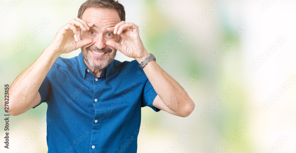 Naklejka premium Handsome middle age elegant senior man over isolated background Trying to open eyes with fingers, sleepy and tired for morning fatigue