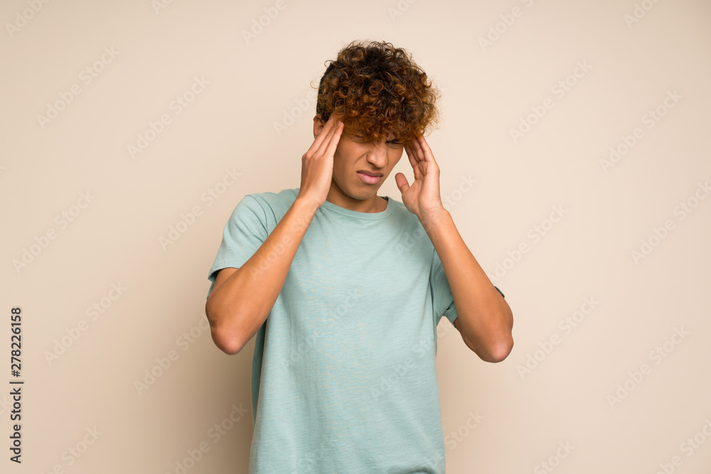African american man with green shirt with headache African american man with green shirt with headache