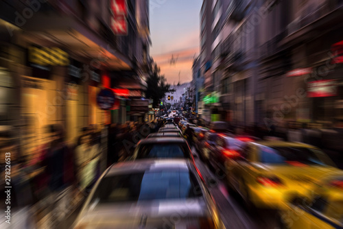 Afternoon traffic on the Ermou street with a long queue of cars and many people in Athens, Greece - Radial zoom defocusing 