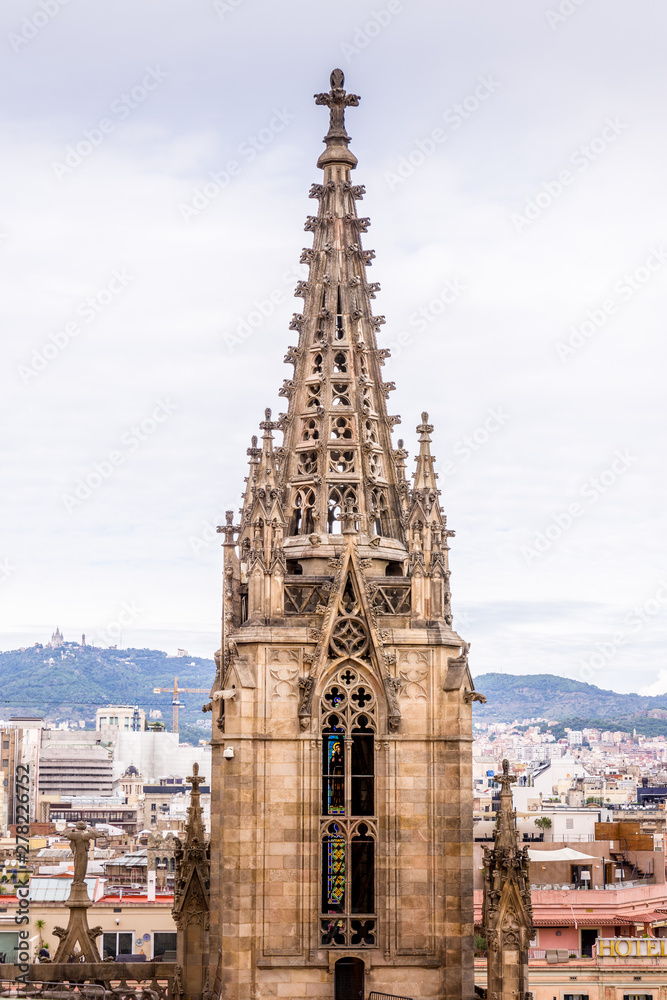 The Cathedral of Barcelona, detail of the main spire in typical gothic style with stone friezes and gargoyles. Barri Gotic, Barcelona.