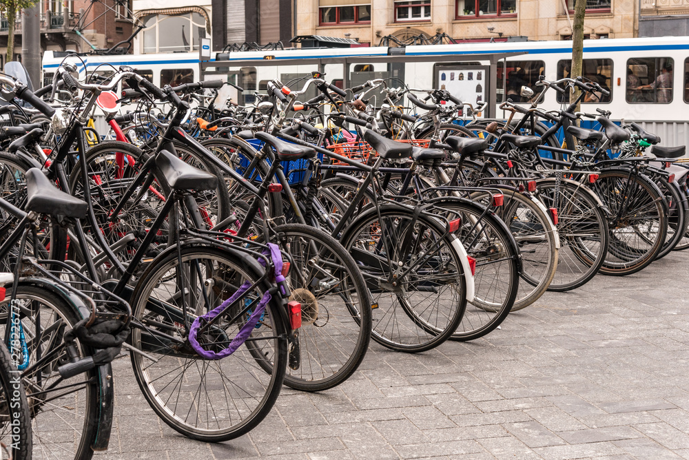 People are using bike for transport in Amsterdam, Netherlands to avoid the air pollution, to move easily in the city and they don't need many parking place too