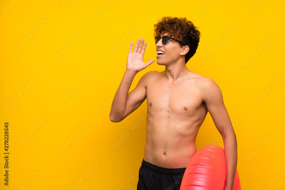 African american man over isolated purple wall shouting with mouth wide open