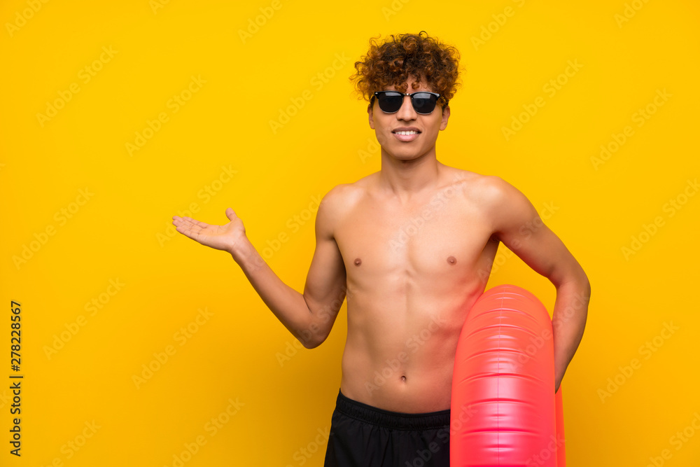 African american man over isolated purple wall holding copyspace imaginary on the palm African american man over isolated purple wall holding copyspace imaginary on the palm
