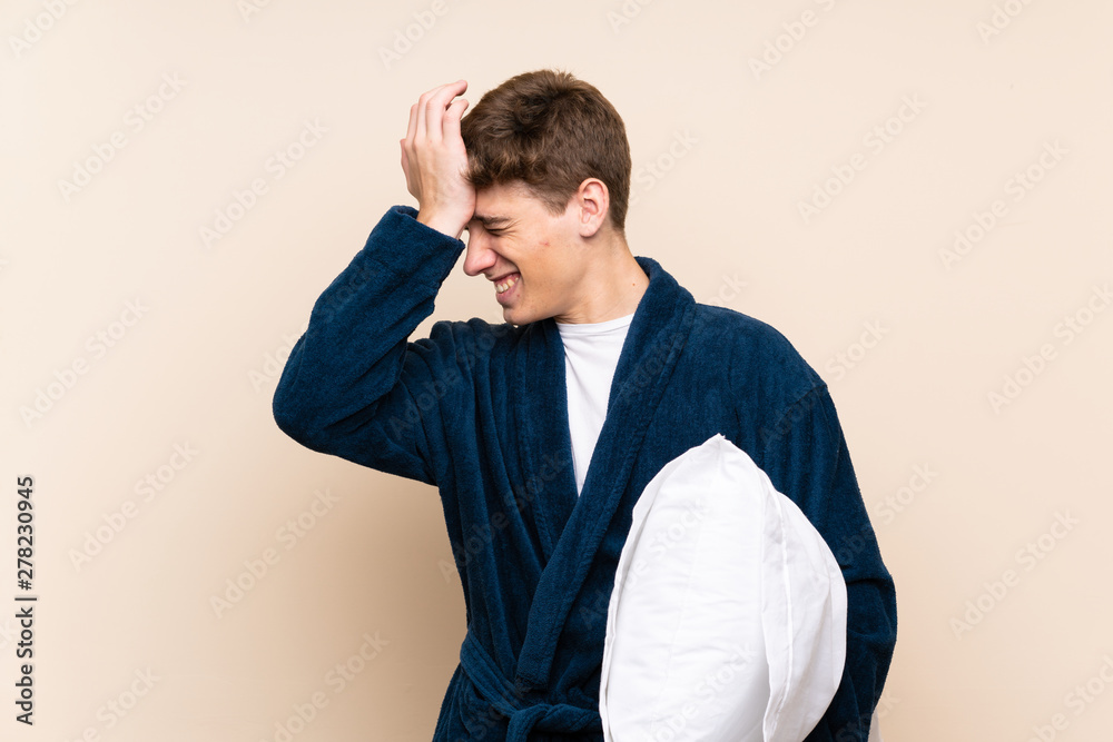 Handsome young man in pajamas over isolated wall has realized something and intending the solution