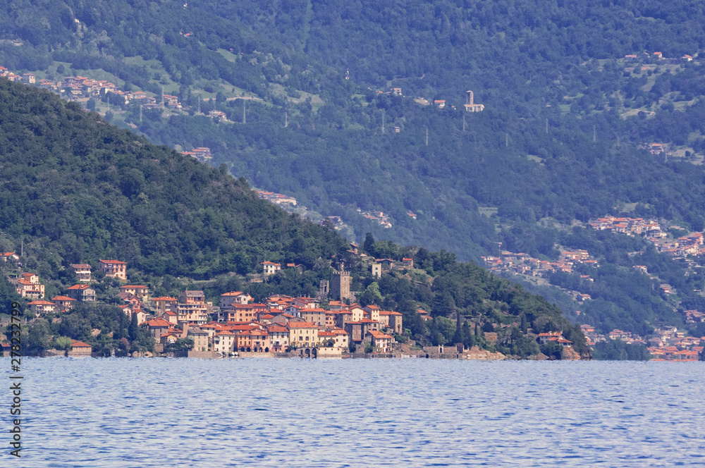 Rezzonico, a medieval village observed from the boat during the crossing of Como Lake, Lombardy. Italy