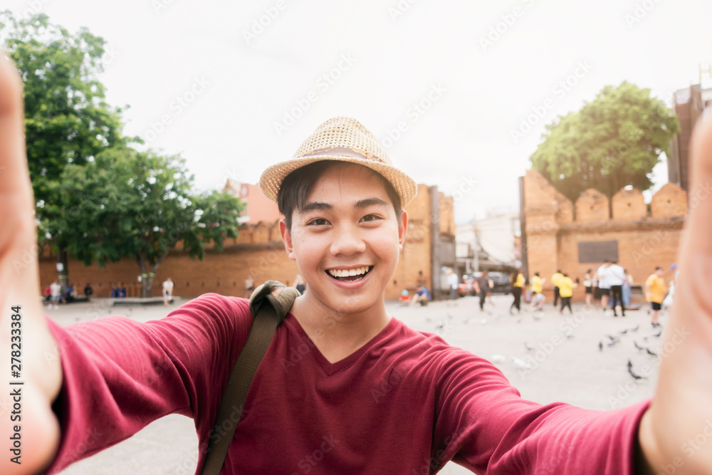 Tourists feeling and happy and fun and use a camera to take a selfie.
