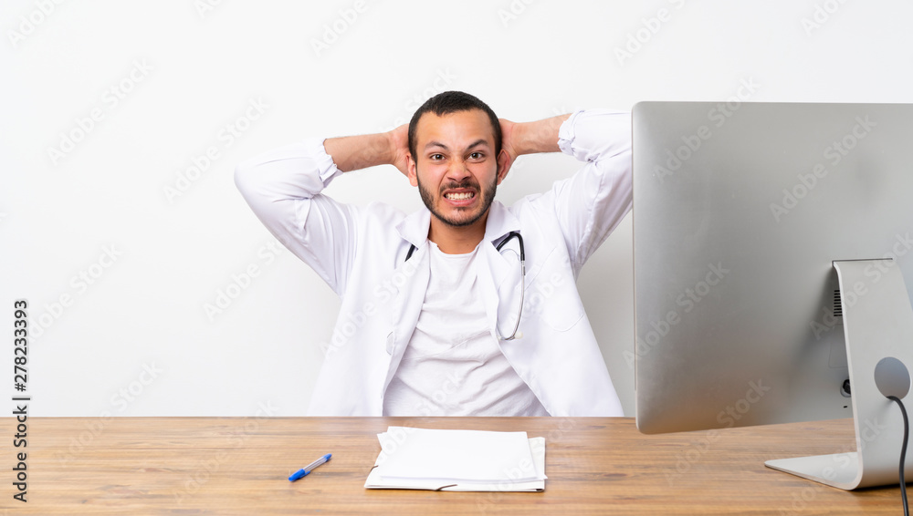 Doctor Colombian man frustrated and takes hands on head Doctor Colombian man frustrated and takes hands on head