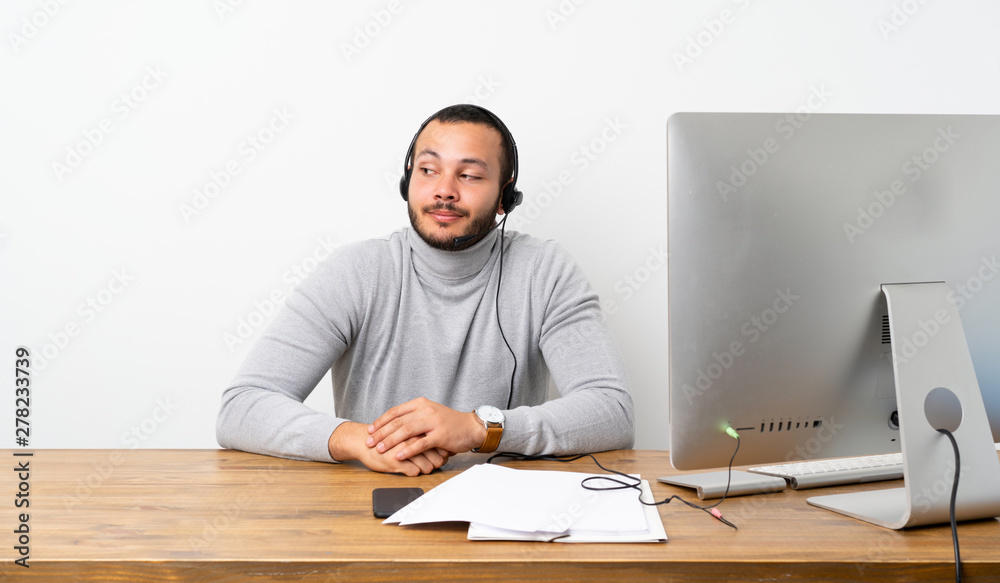Telemarketer Colombian man making doubts gesture looking side Telemarketer Colombian man making doubts gesture looking side