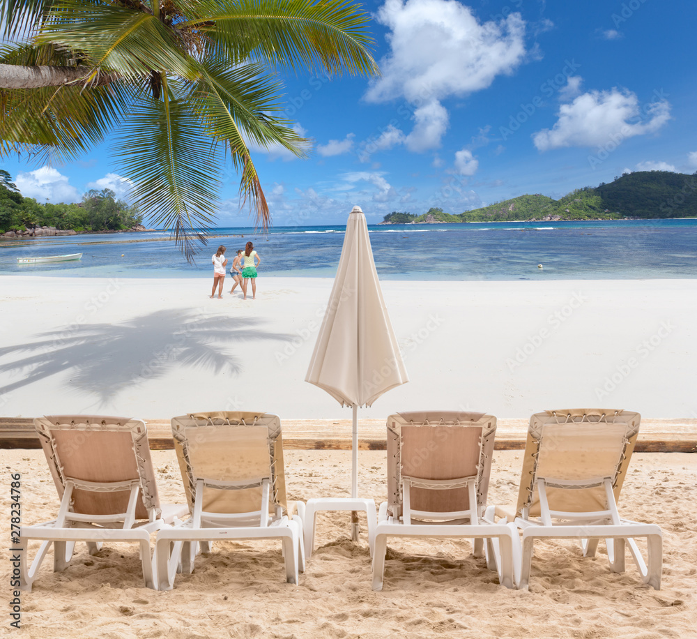 two chairs and umbrella on the beach, Seychelles 