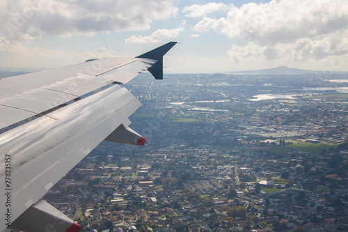 Airplane window view, approach Auckland Airport in Auckland, North Island, New Zealand photo