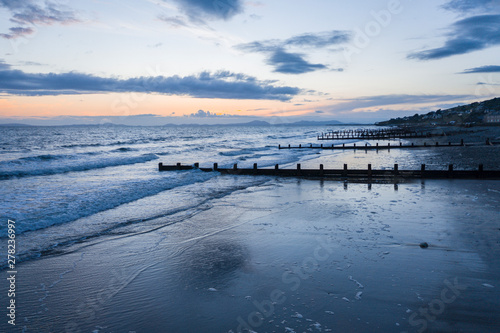 Fototapeta Naklejka Na Ścianę i Meble -  Stormy Twilight Sky Over Barmouth Beach in Wales,UK