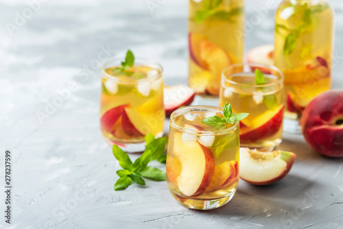 Summer cold tea with peaches and mint