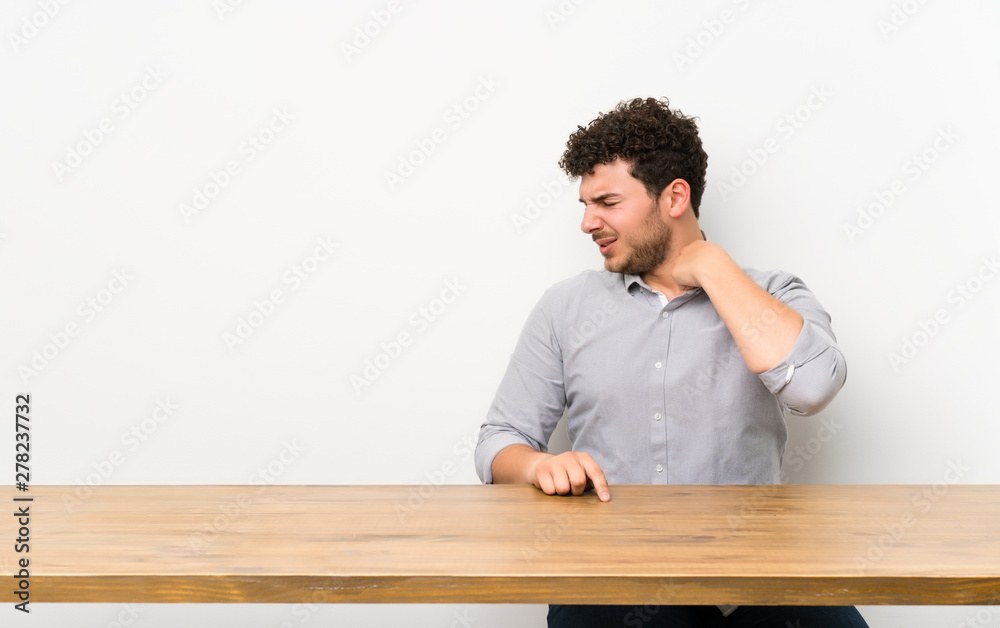 Young man with a table with tired and sick expression Young man with a table with tired and sick expression