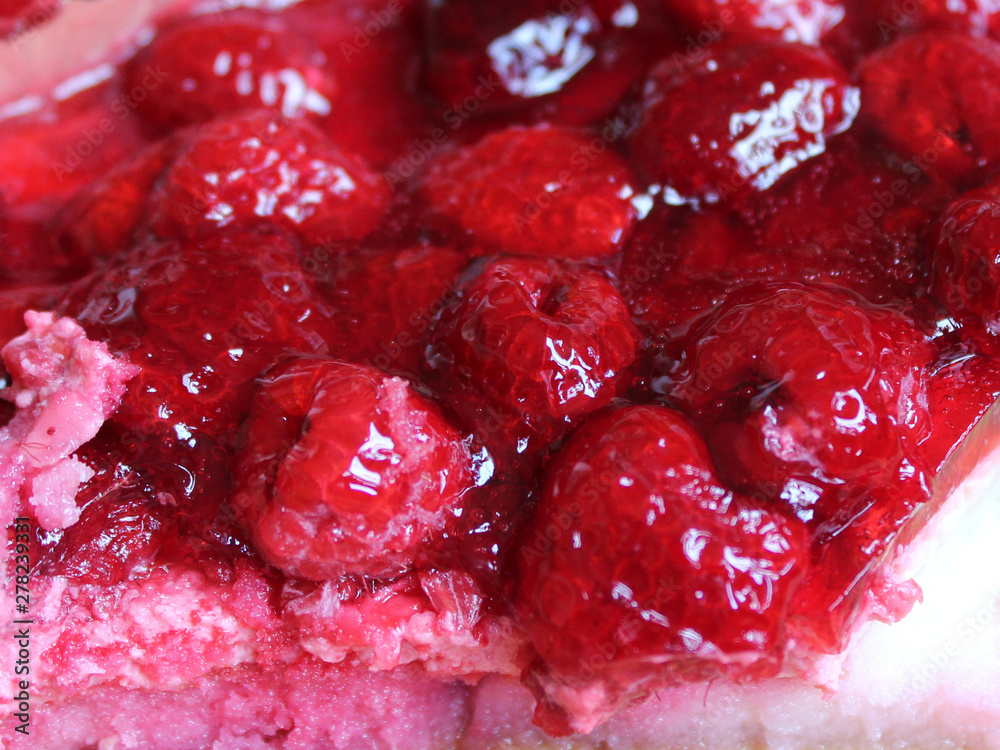 A piece of raspberry pie in jelly close-up A piece of raspberry pie in jelly close-up