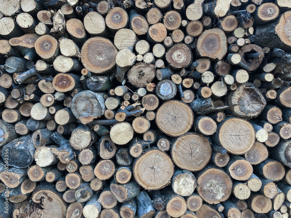 Firewood for heating, fires, fireplaces. Background from sawed tree trunks. Firewood for heating, fires, fireplaces. Background from sawed tree trunks.