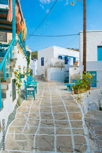 Fototapeta Naklejka Na Ścianę i Meble -  Street view of Chorio village with paved alleys and traditional cycladic architecture in Kimolos island in Cyclades, Greece