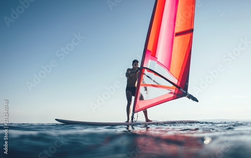 Obraz na płótnie Windsurfer catch the wind on windsurf board 