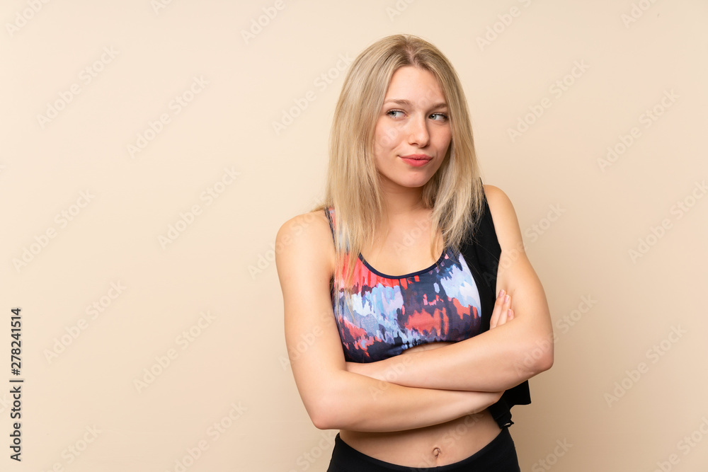 Young blonde sport woman over isolated wall thinking an idea Young blonde sport woman over isolated wall thinking an idea