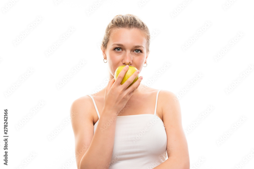Young blonde woman over isolated white background with an apple Young blonde woman over isolated white background with an apple