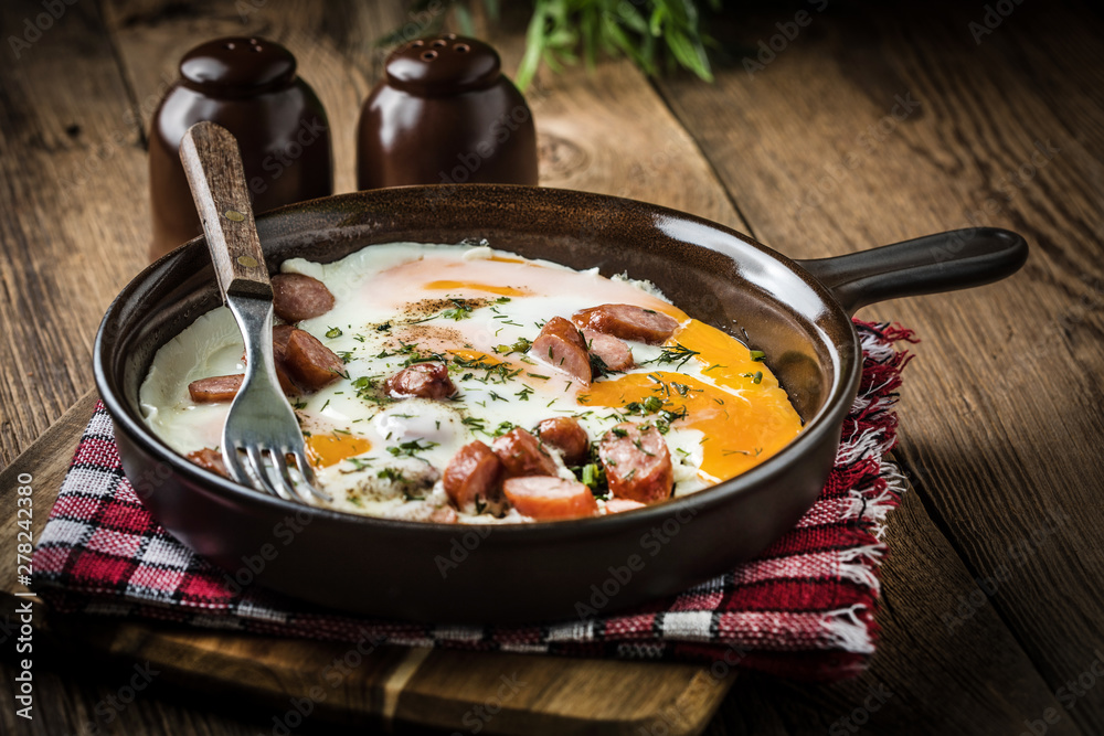 Tasty cooked egg with chopped sausages. Tasty cooked egg with chopped sausages.