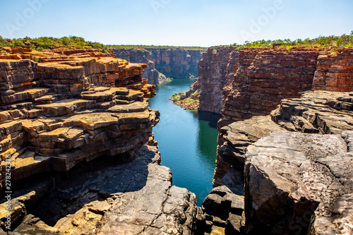 high angel view over King George River Gorge and plateau in the Kimberleys  with lush bushes and sandstone formation in  the foreground and background photo
