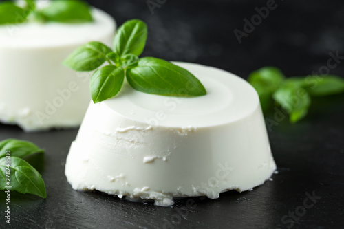 Wallpaper Mural Fresh Ricotta cheese with basil leaf on black rustic table. selected focus Torontodigital.ca
