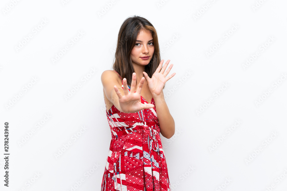 Caucasian girl in red dress over isolated white wall nervous stretching hands to the front Caucasian girl in red dress over isolated white wall nervous stretching hands to the front