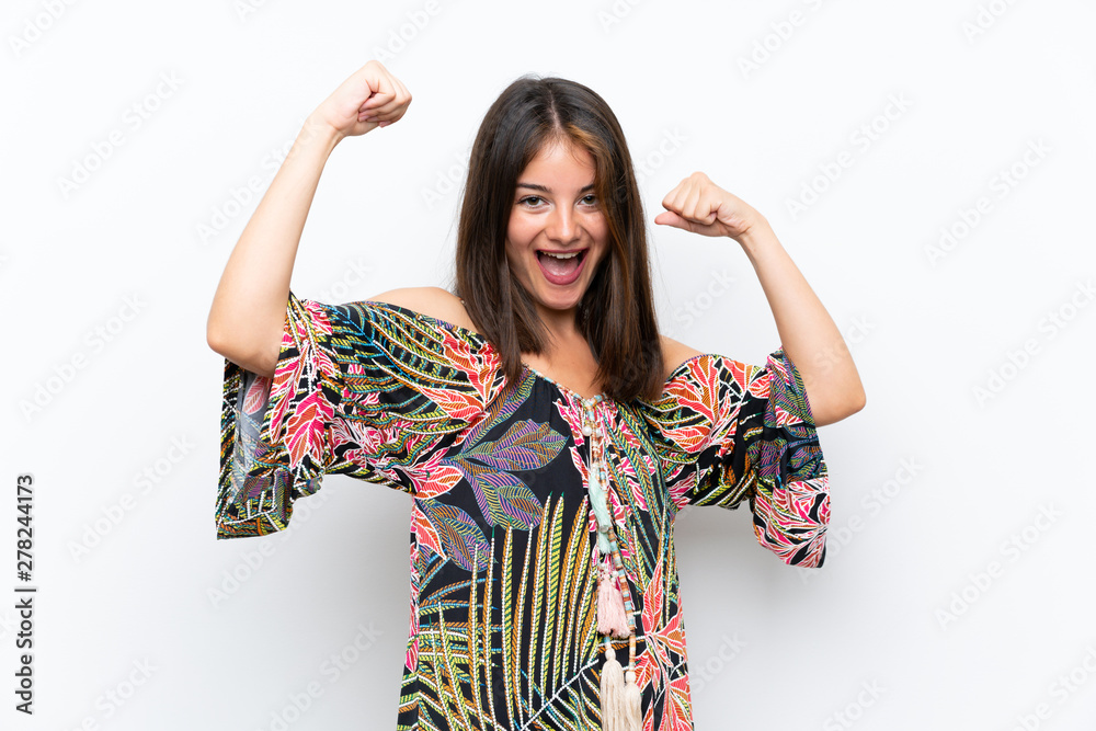 Caucasian young woman in colorful dress on isolated white background celebrating a victory Caucasian young woman in colorful dress on isolated white background celebrating a victory